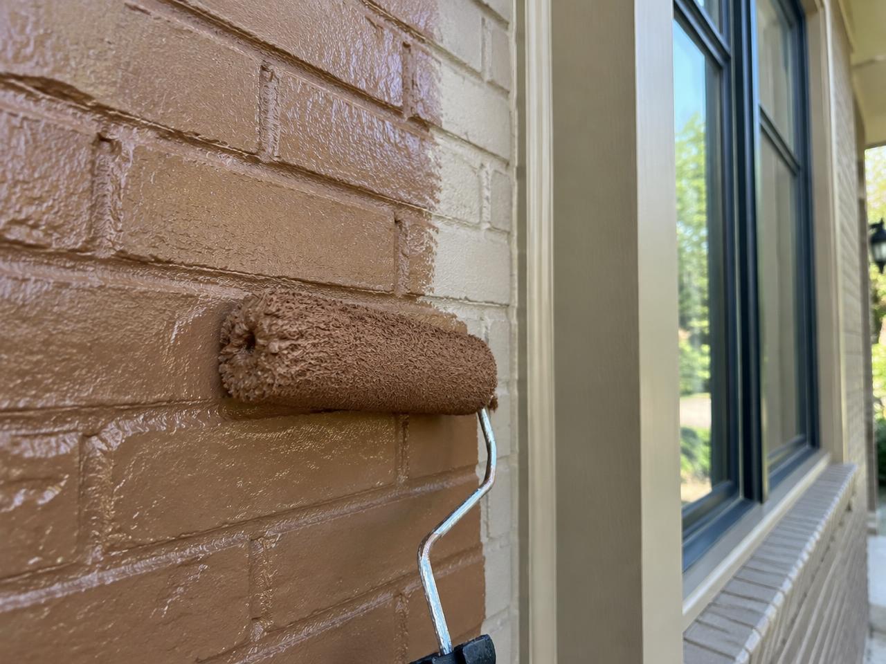 Brick exterior being primed and painted bronze on a Burke County home