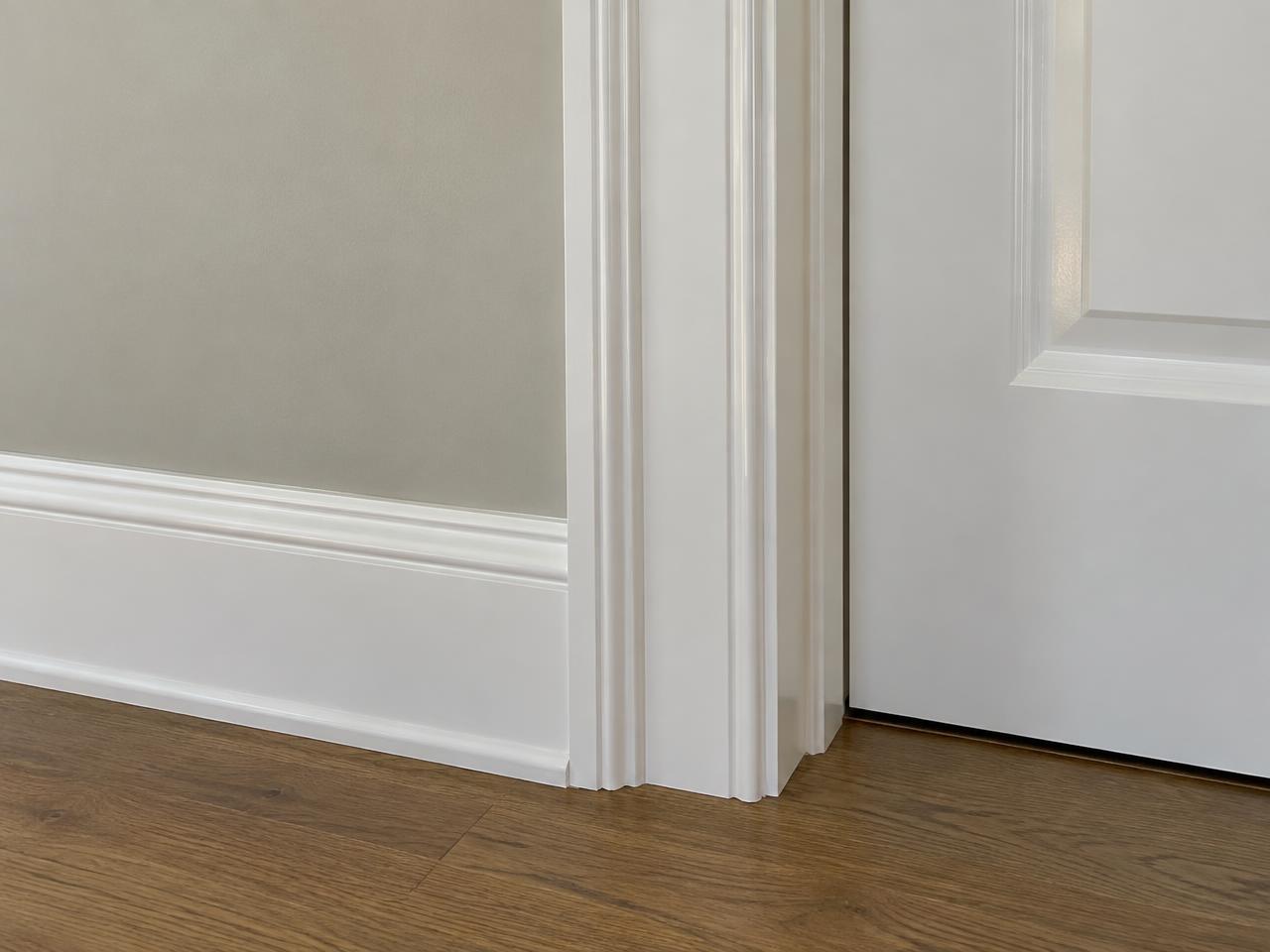 Crisp white painted door casing and baseboard trim detail